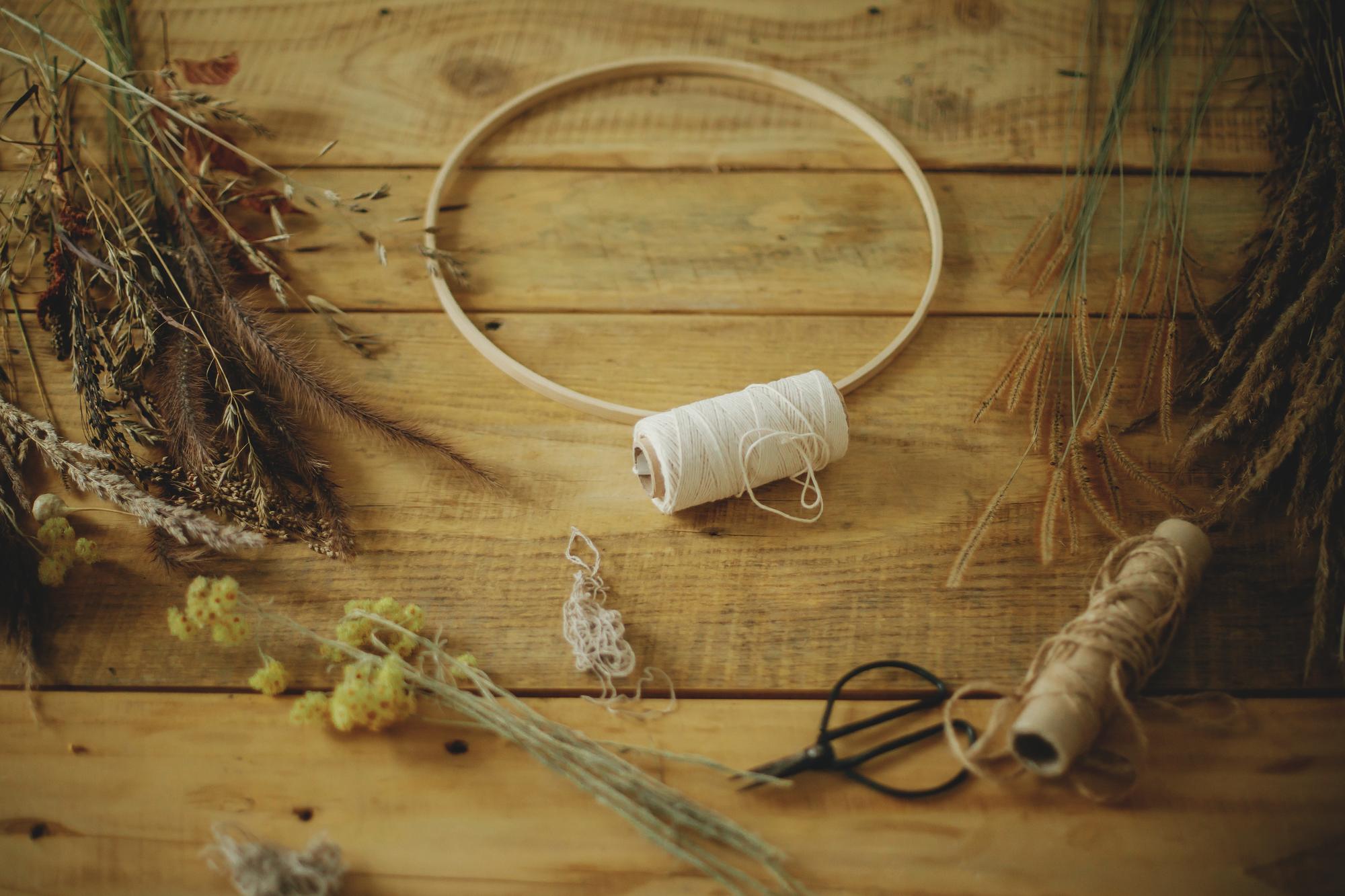 workspace with hoop and threads on wooden table