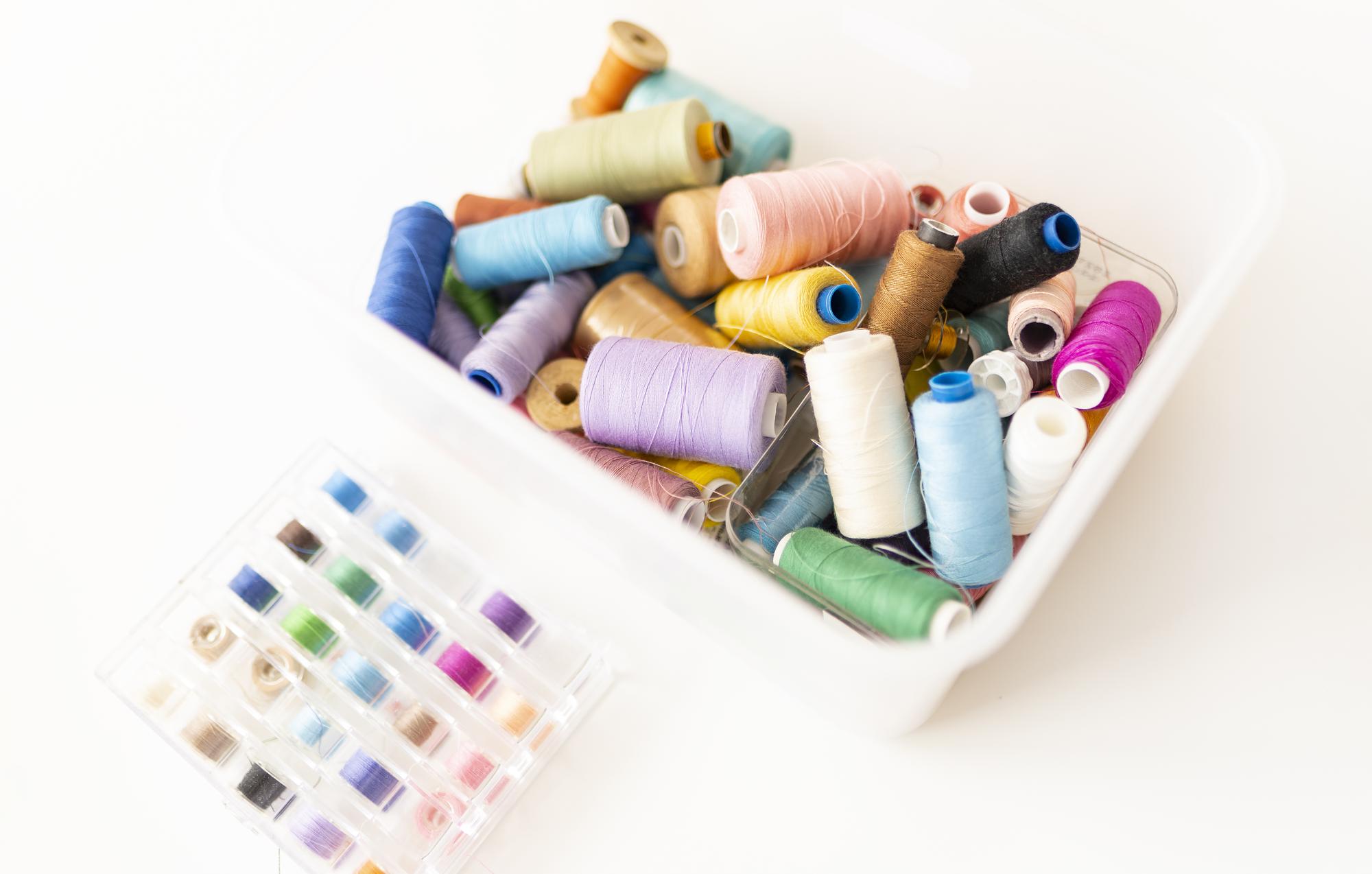 selection of embroidery threads and needles